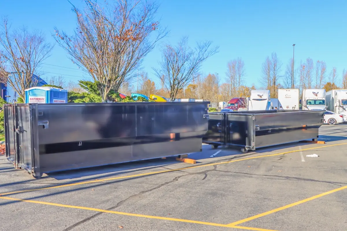 Professional dumpster rental service with roll-off container on residential driveway in Woods Creek